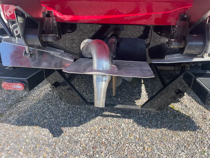 Slide: The Image of Close-up of the propeller and rudder of a 2021 Supra SE boat. - 12