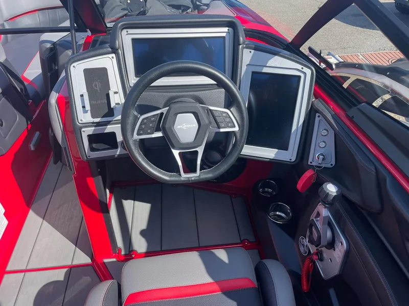 Slide: The Image of 2021 Supra SE boat dashboard with steering wheel and touchscreen displays. - 14
