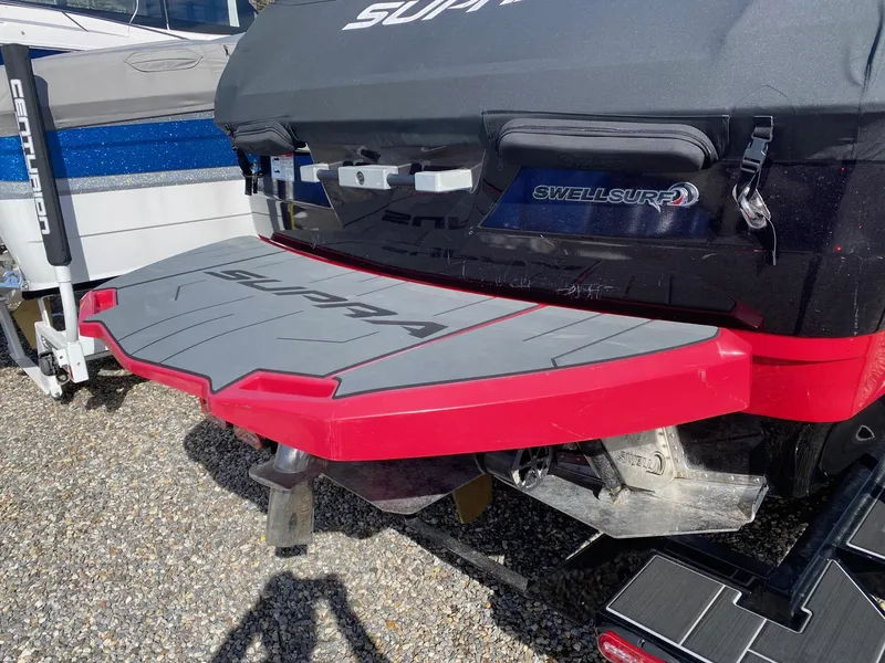 Slide: The Image of 2021 Supra SE boat with SwellSurf system and red swim platform. - 4