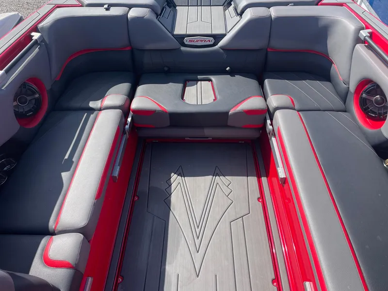 Slide: The Image of 2021 Supra SE boat interior with red and gray seating. - 8