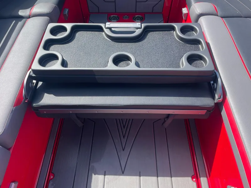 Slide: The Image of 2021 Supra SE boat interior with foldable table and cup holders. - 9