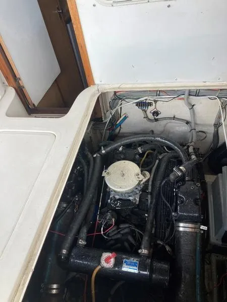 Slide: The Image of 1987 Bertram 28 Sport Fisherman engine compartment with visible wiring and components. - 9