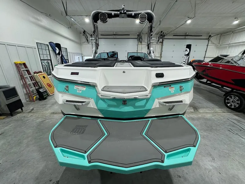 Slide: The Image of 2019 MasterCraft XStar boat in a showroom, rear view. - 10
