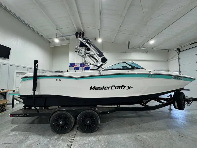 Slide: The Image of 2019 MasterCraft XStar boat on trailer in indoor storage facility. - 13