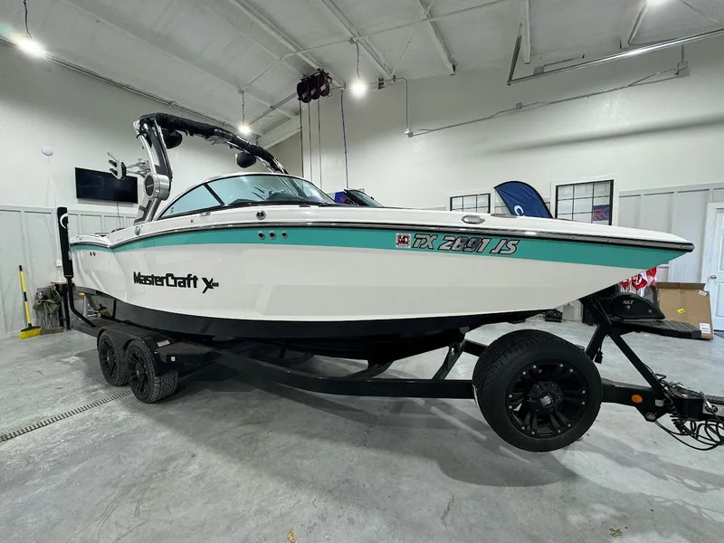 Slide: The Image of 2019 MasterCraft XStar boat on trailer in indoor storage facility. - 14