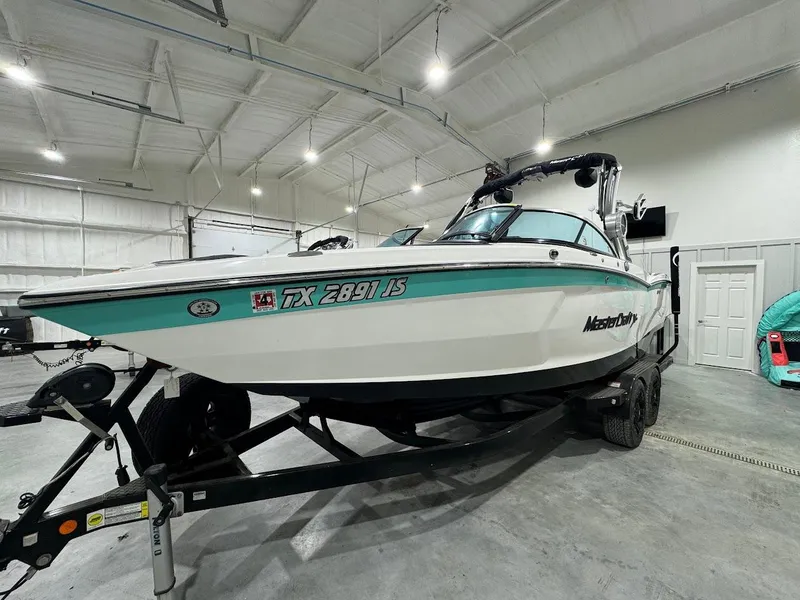 Slide: The Image of 2019 MasterCraft XStar boat on trailer in indoor storage facility. - 15