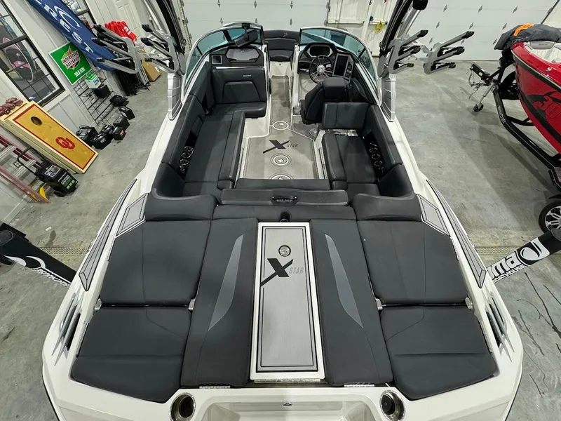 Slide: The Image of 2019 MasterCraft XStar boat interior with black seating and modern design. - 16