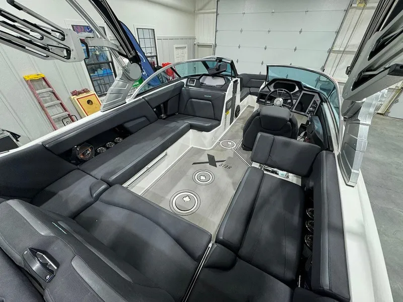 Slide: The Image of 2019 MasterCraft XStar interior with black seating and modern dashboard. - 17