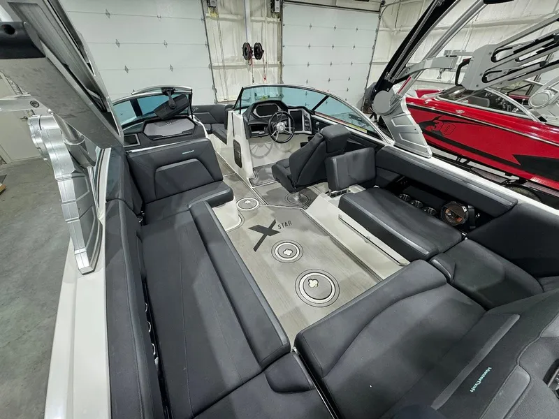 Slide: The Image of 2019 MasterCraft XStar boat interior with black seating and modern dashboard. - 18