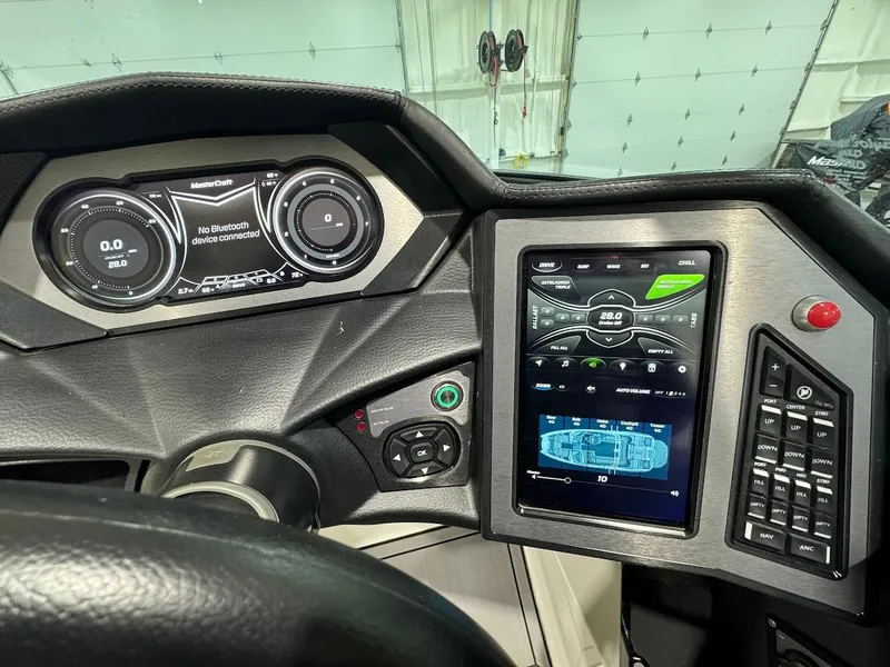 Slide: The Image of 2019 MasterCraft XStar dashboard with digital displays and control panel. - 20