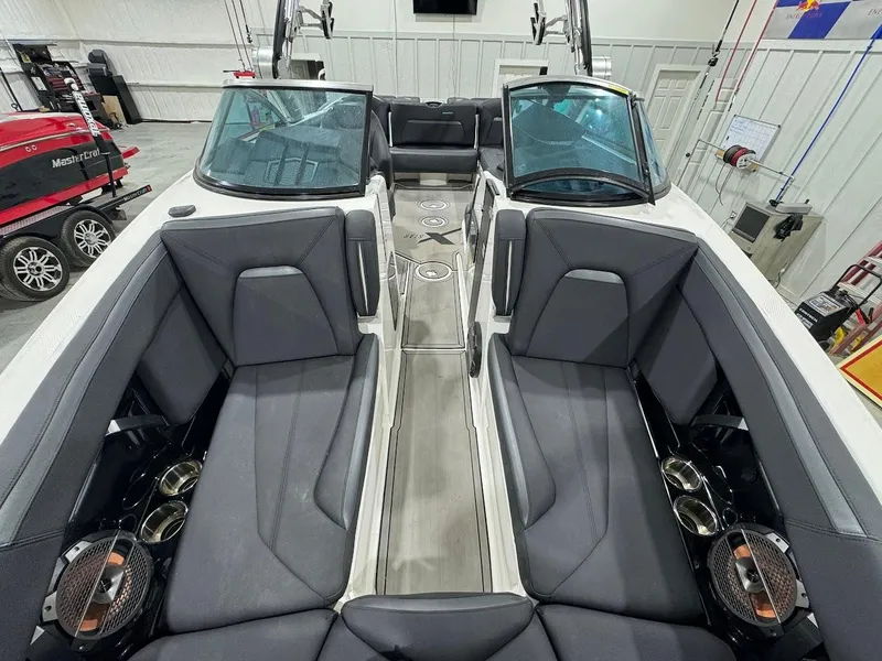 Slide: The Image of 2019 MasterCraft XStar boat interior with gray seating and cup holders. - 23