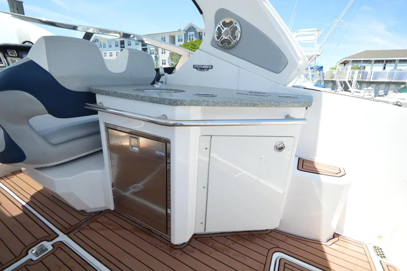Slide: The Image of 2013 Chaparral 327 SSX boat interior with seating and kitchenette area. - 11