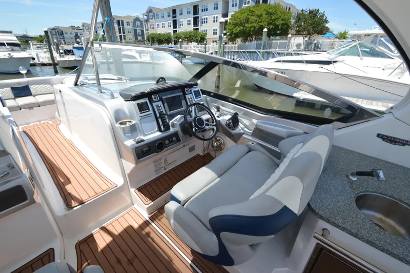 Slide: The Image of 2013 Chaparral 327 SSX boat interior with modern dashboard and seating. - 13