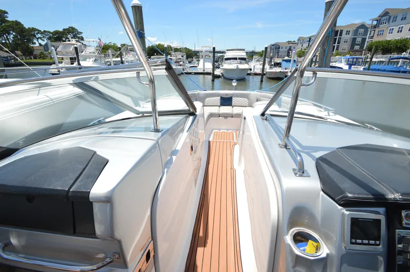 Slide: The Image of 2013 Chaparral 327 SSX boat interior with sleek design and marina view. - 15