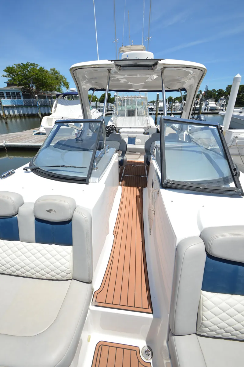 Slide: The Image of 2013 Chaparral 327 SSX boat interior with cushioned seating and open deck. - 20