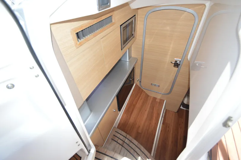 Slide: The Image of Interior of 2013 Chaparral 327 SSX boat with wood flooring and cabinetry. - 26