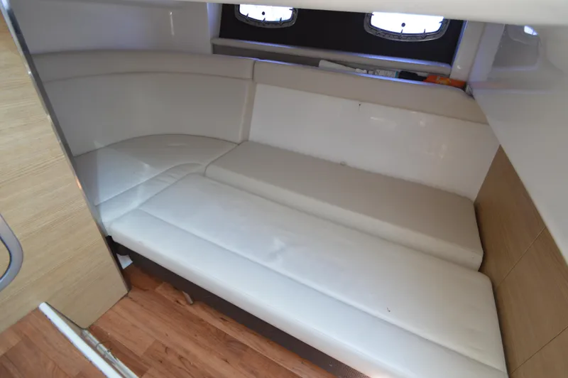 Slide: The Image of Interior cabin of 2013 Chaparral 327 SSX with white seating and wood flooring. - 28