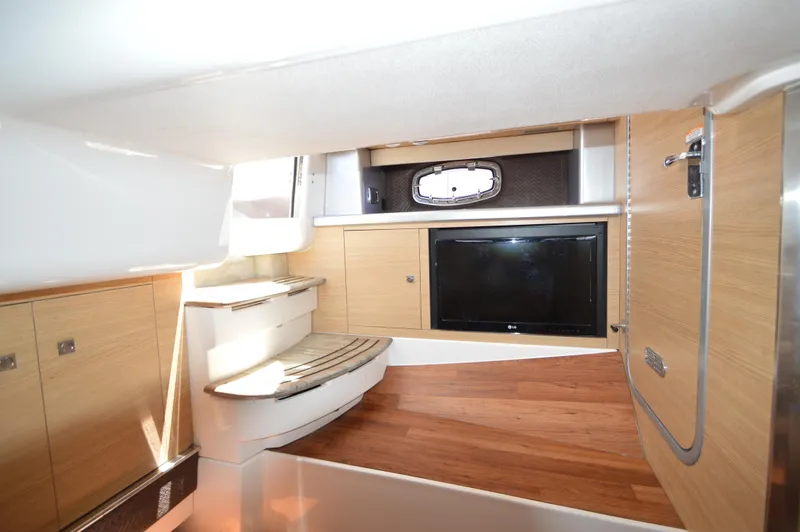 Slide: The Image of Interior of 2013 Chaparral 327 SSX boat with wood flooring and built-in TV. - 29