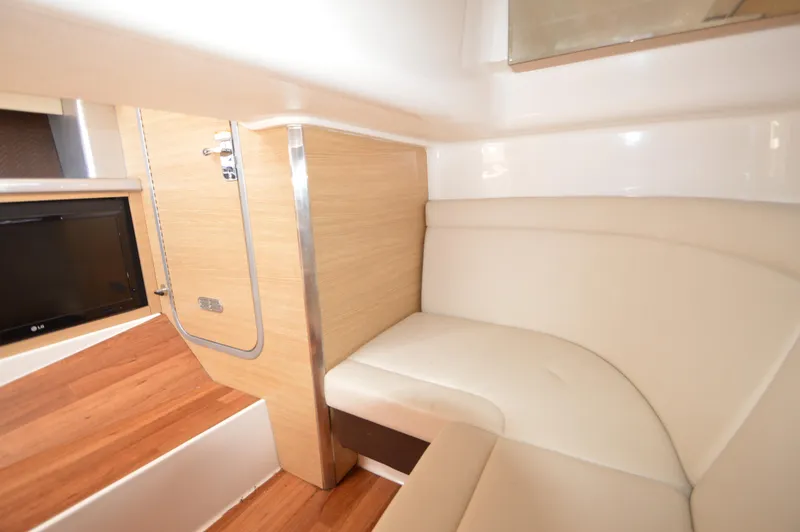 Slide: The Image of Interior of 2013 Chaparral 327 SSX boat with beige seating and wood accents. - 30