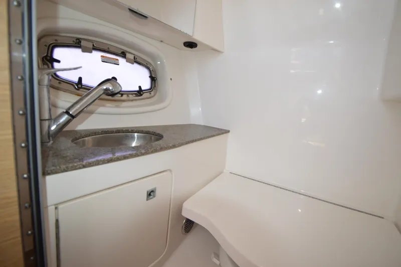 Slide: The Image of 2013 Chaparral 327 SSX boat interior with sink and porthole window. - 32