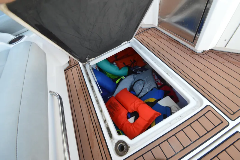 Slide: The Image of Storage compartment on 2013 Chaparral 327 SSX boat with life jackets inside. - 33