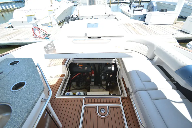 Slide: The Image of 2013 Chaparral 327 SSX boat engine compartment with open hatch, docked at marina. - 34