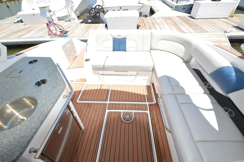 Slide: The Image of Luxurious interior of 2013 Chaparral 327 SSX boat with white seating and wooden flooring. - 9