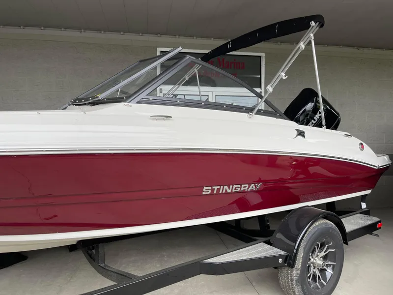 Slide: The Image of 2024 Stingray 191 DC boat with red and white exterior on a trailer. - 10