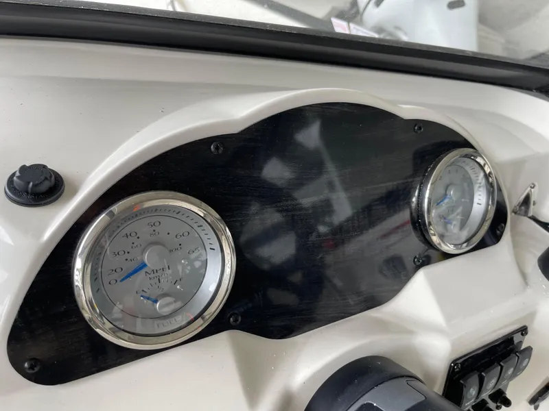 Slide: The Image of Dashboard of 2024 Stingray 191 DC boat with speedometer and tachometer. - 13
