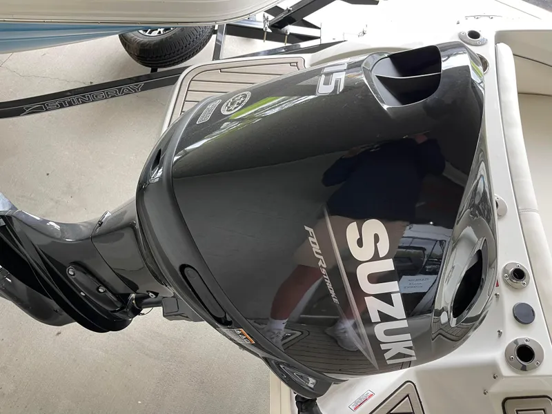 Slide: The Image of 2024 Stingray 191 DC boat with Suzuki outboard motor. - 14