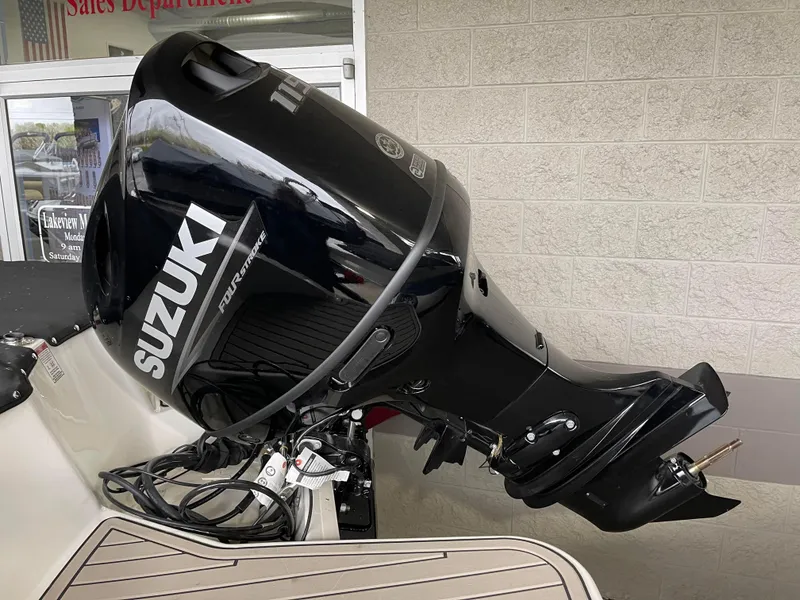 Slide: The Image of 2024 Stingray 191 DC boat with Suzuki outboard motor. - 15