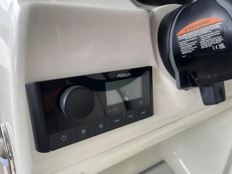 Slide: The Image of 2024 Stingray 191 DC boat dashboard with Fusion audio system. - 16