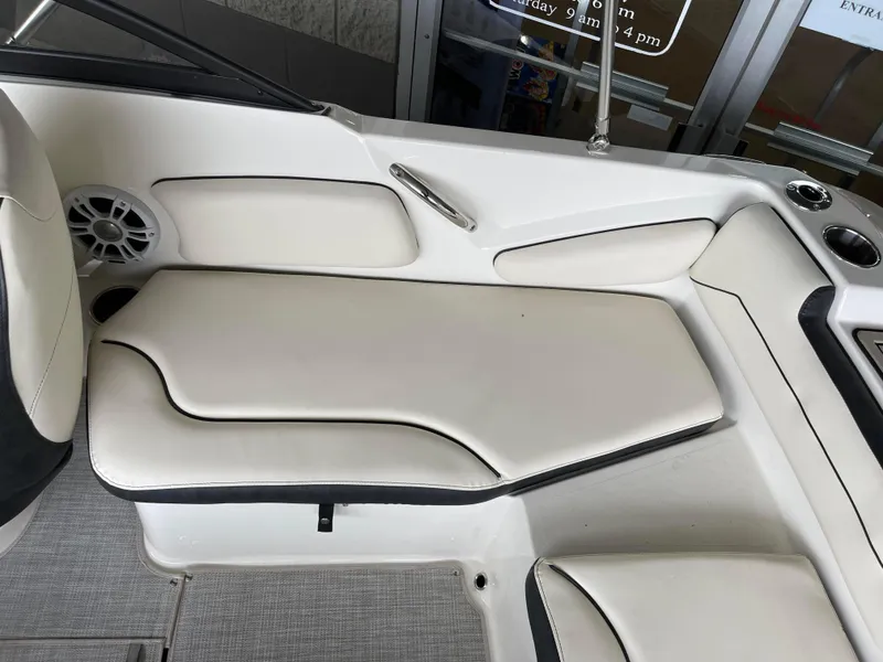 Slide: The Image of 2024 Stingray 191 DC boat interior with white cushioned seating and speaker. - 19