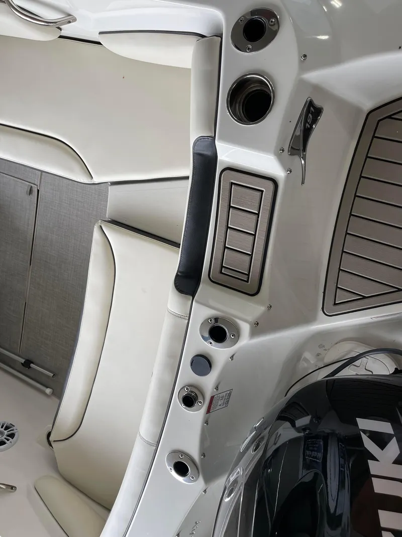 Slide: The Image of 2024 Stingray 191 DC boat interior with white seating and control panel. - 4