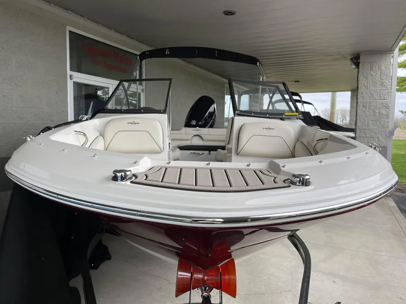 Slide: The Image of 2024 Stingray 191 DC boat with white and red exterior, displayed in a showroom. - 7