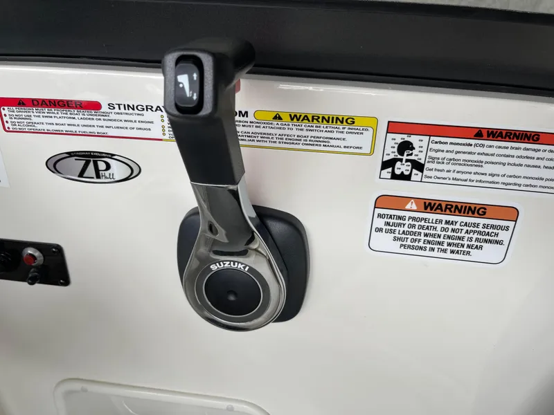 Slide: The Image of 2024 Stingray 191 DC boat control lever with Suzuki branding and safety warnings. - 9