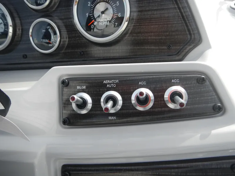 Slide: The Image of Control panel of 2024 Lowe SF 212 WT boat with switches and gauges. - 18