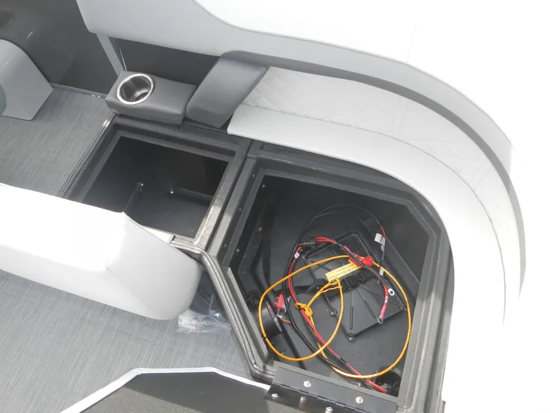 Slide: The Image of 2024 Lowe SF 212 WT boat storage compartment with wiring and cup holder. - 23