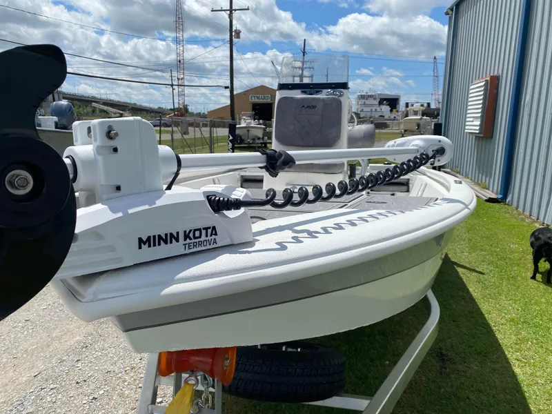 Slide: The Image of 2024 Avid 19FSX boat with Minn Kota Terrova trolling motor, parked outdoors. - 11