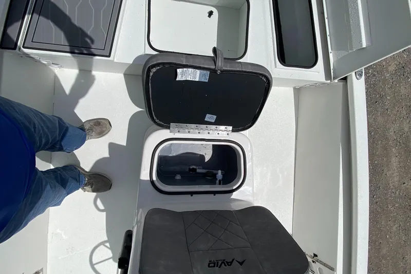Slide: The Image of 2024 Avid 19FSX boat interior with open storage compartments. - 12