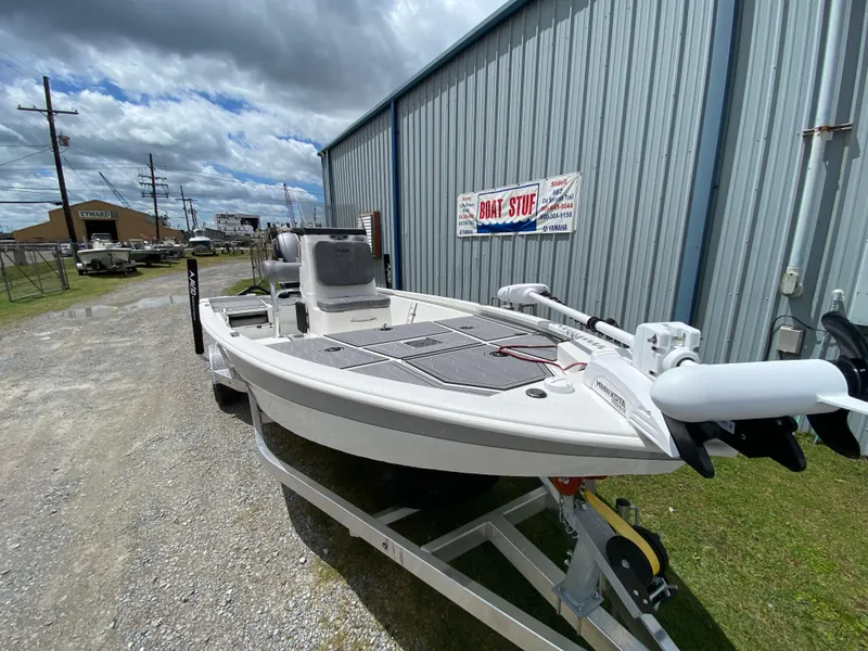 Slide: The Image of 2024 Avid 19FSX boat on trailer outside a metal building. - 3