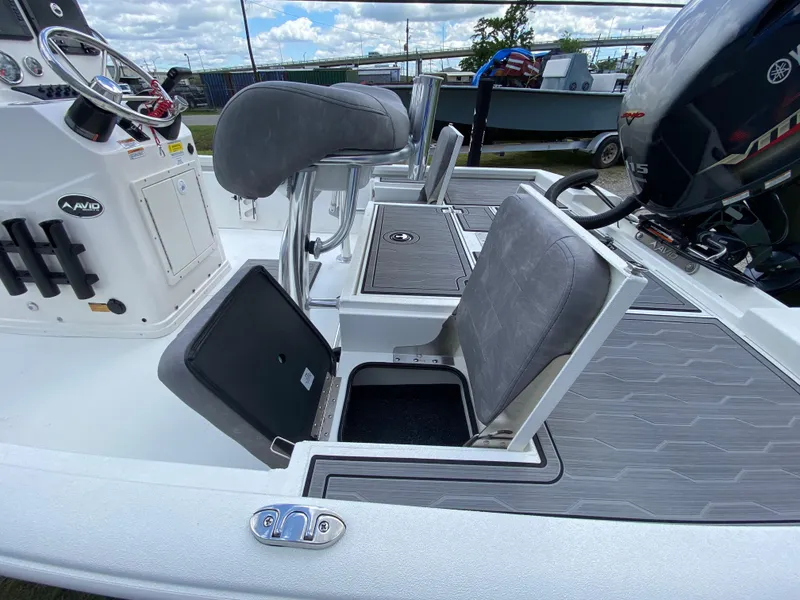 Slide: The Image of 2024 Avid 19FSX boat interior with seating and storage compartments. - 7