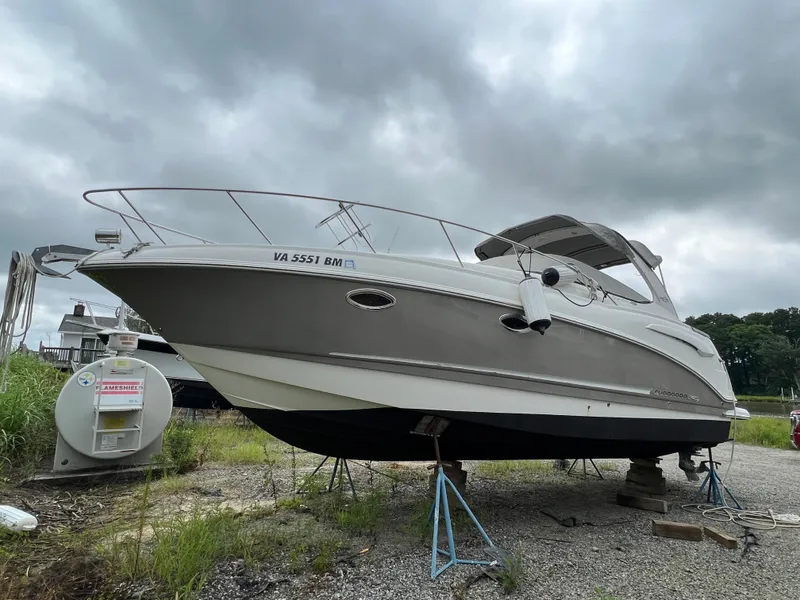 The Image of 2008 Chaparral Signature 290 boat on stands under cloudy sky. - 0