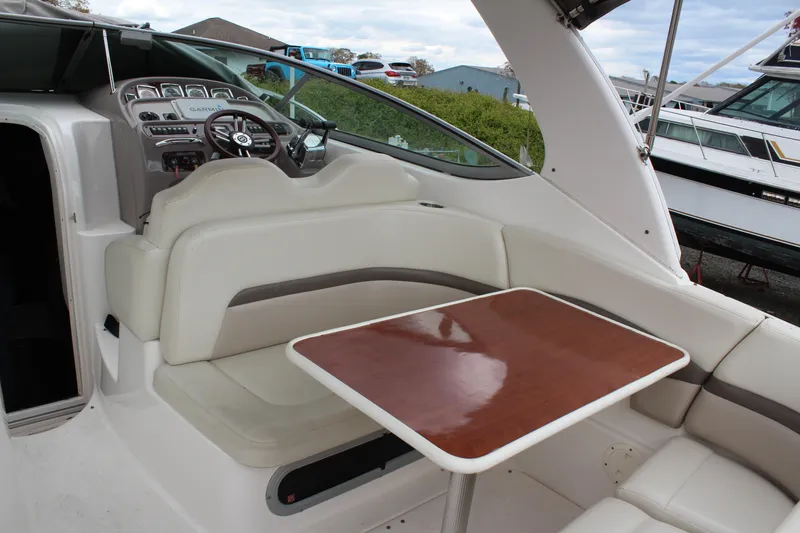 Slide: The Image of 2008 Chaparral Signature 290 boat interior with seating and wooden table. - 10