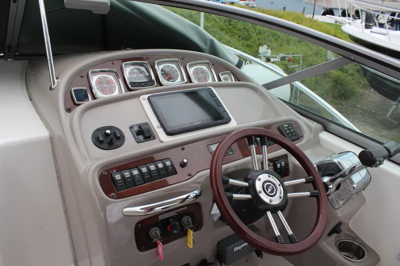 Slide: The Image of 2008 Chaparral Signature 290 boat dashboard with steering wheel and navigation controls. - 13