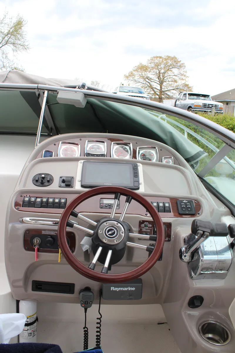 Slide: The Image of 2008 Chaparral Signature 290 helm with steering wheel, gauges, and Raymarine navigation system. - 14