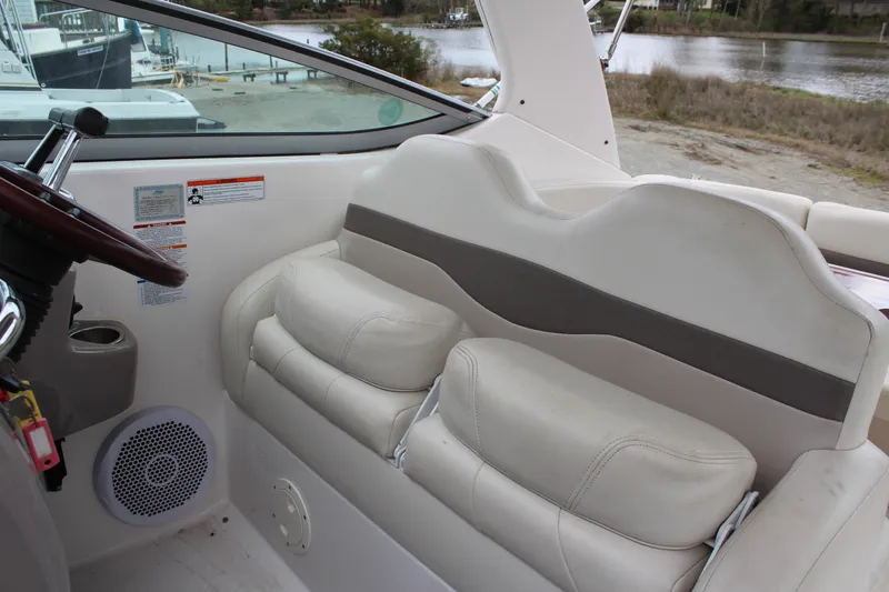 Slide: The Image of 2008 Chaparral Signature 290 boat interior with white seating and steering wheel. - 24