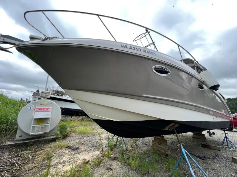 Slide: The Image of 2008 Chaparral Signature 290 boat on stands, overcast sky, grassy surroundings. - 3