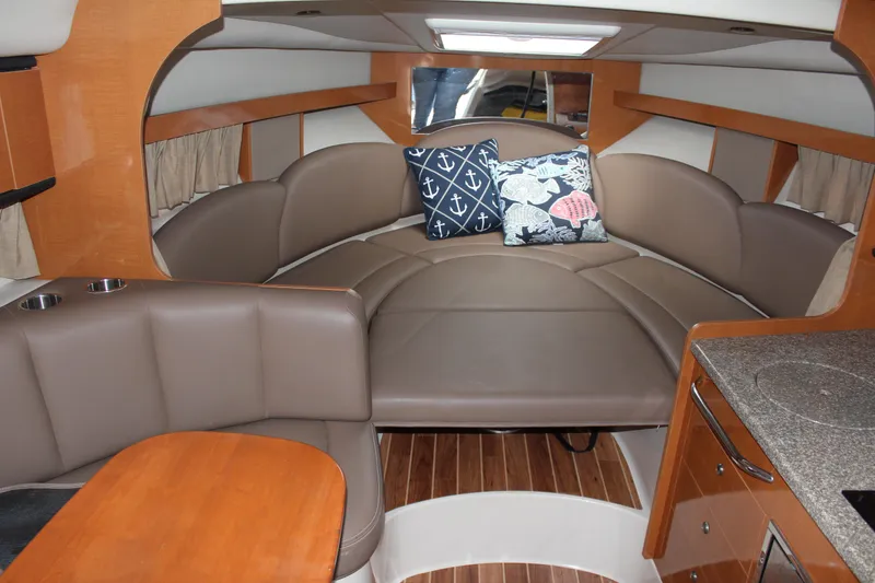 Slide: The Image of Interior of 2008 Chaparral Signature 290 boat with cozy seating and nautical-themed pillows. - 31