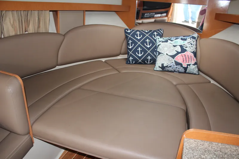 Slide: The Image of Interior of 2008 Chaparral Signature 290 with brown seating and nautical-themed pillows. - 32